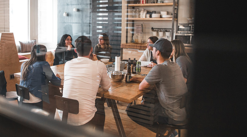 people in meeting around table in office