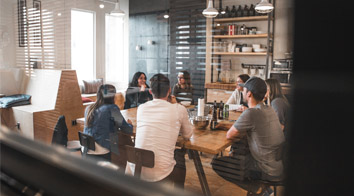 people in meeting around table in office