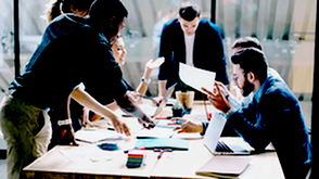 people in meeting around table in office
