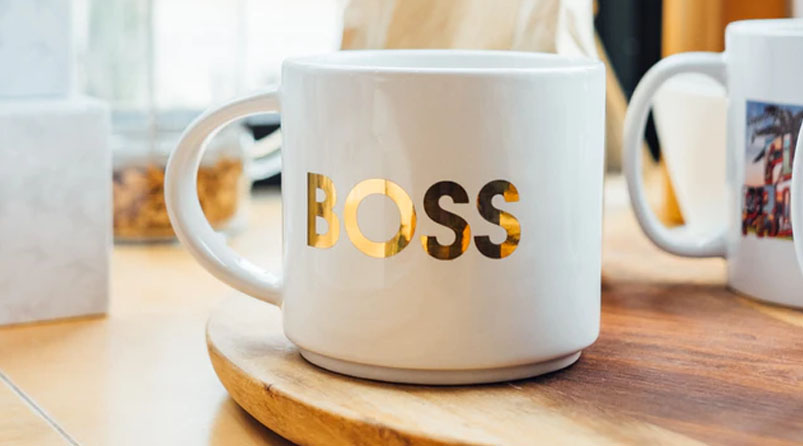 white mug with gold foil BOSS on wooden board